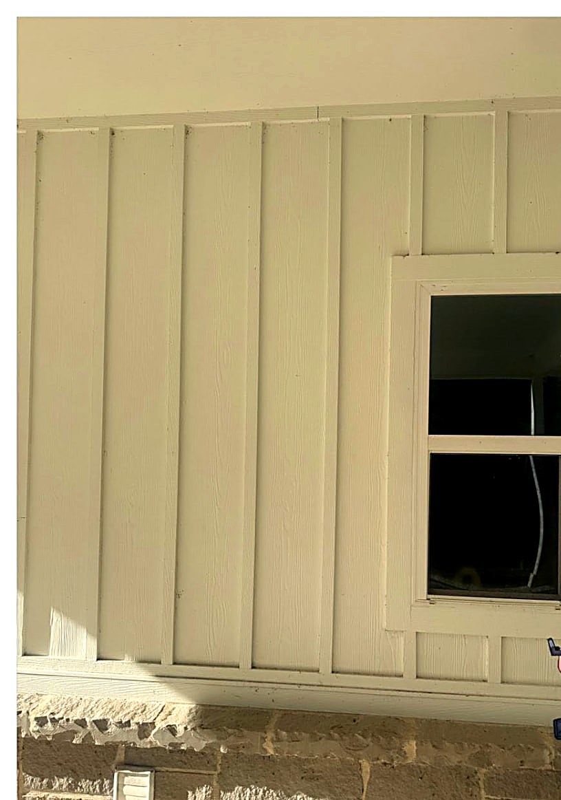 Dull, dirt-shaded board-and-batten siding before soft washing