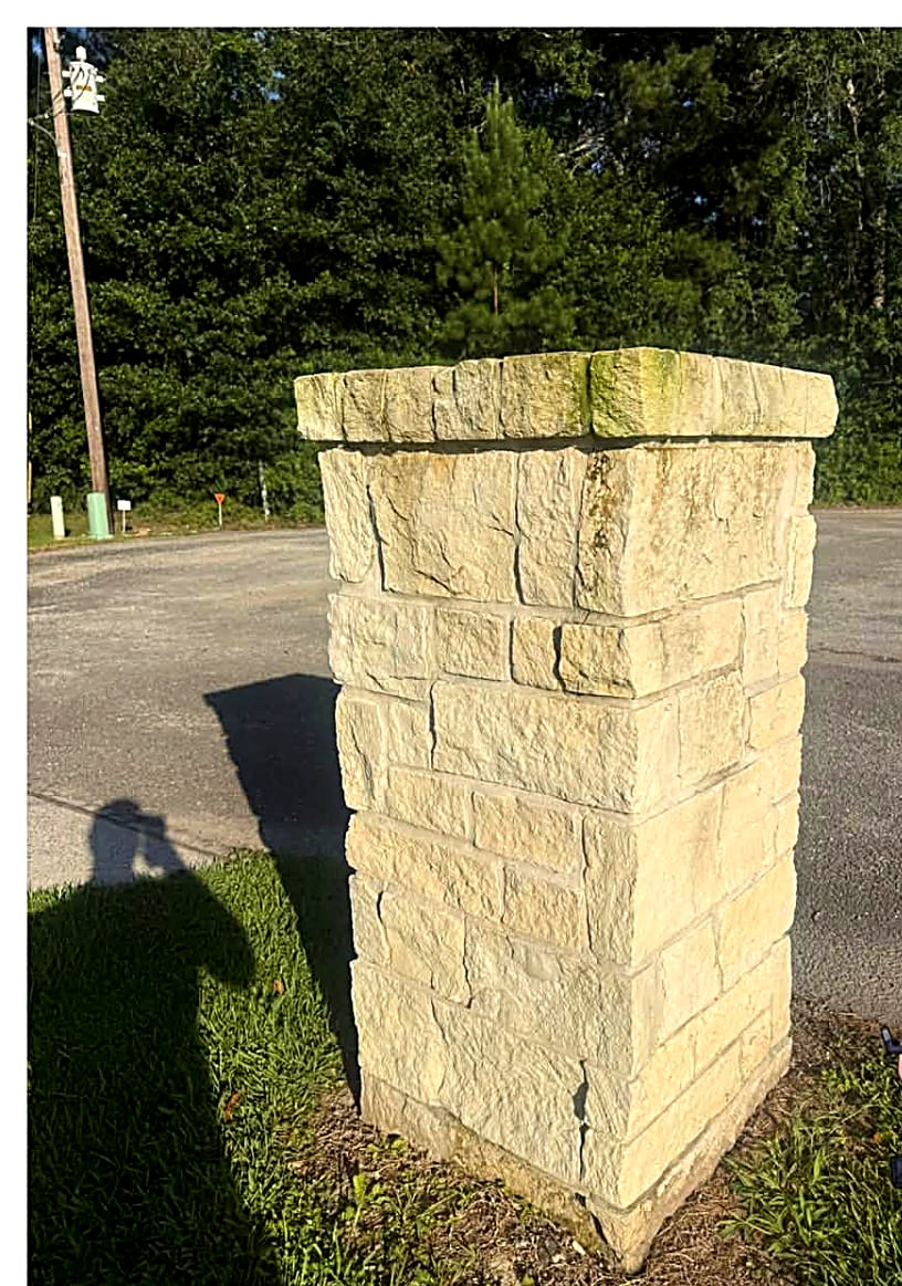 Limestone entry column with algae staining before cleaning
