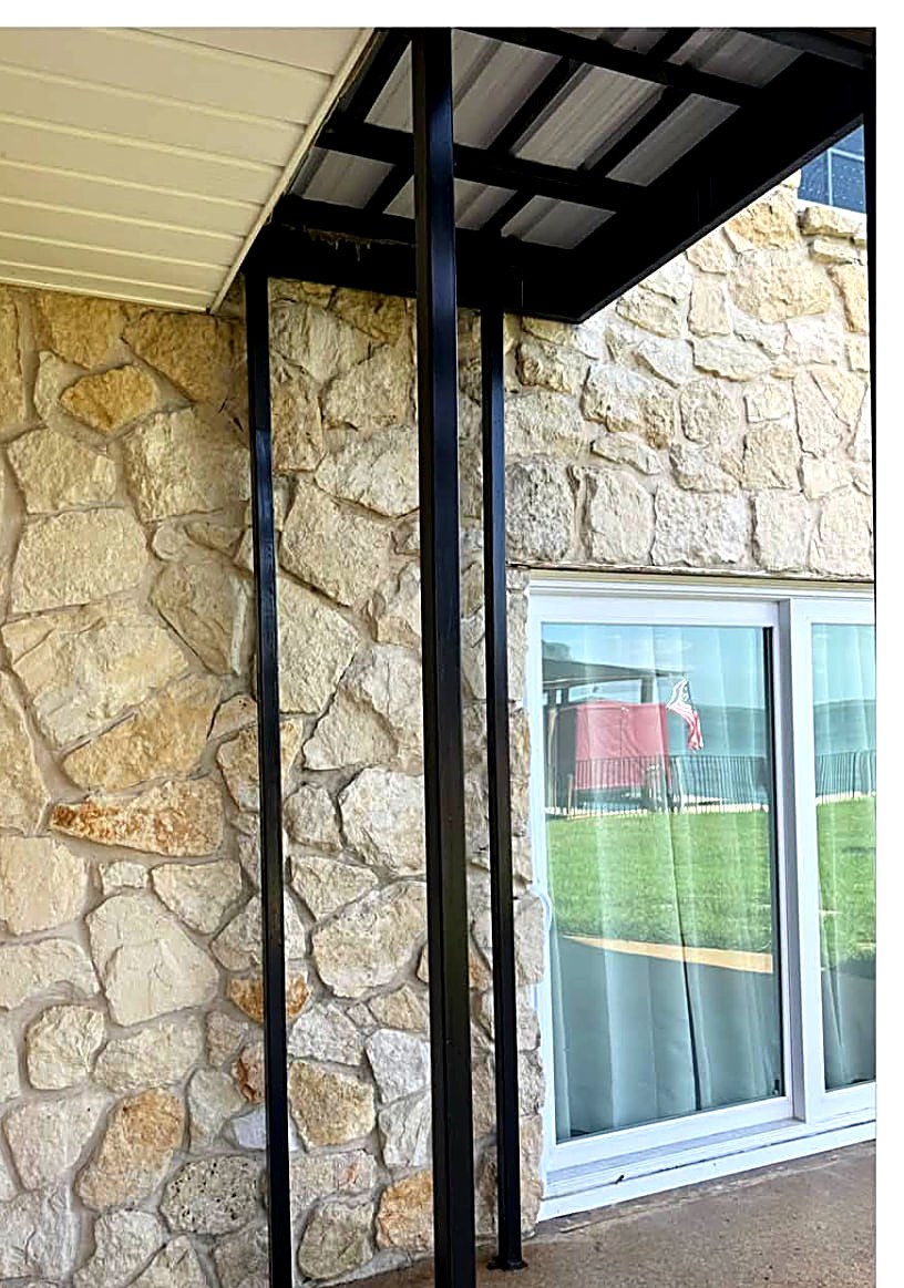 Clean stone patio wall after soft washing